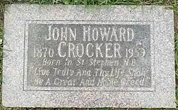 Flat red granite stone inscribed with Crocker's name, birth and death years, birth place, and the quote "Live truly and thy life shall be a great and noble creed".