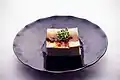 Chilled tofu served with soy sauce seasonings