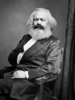Black-and-white portrait photograph of Marx sitting