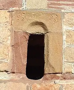 Window of a church tower in Ober-Olm (Germany, 12th century) with apotropaic symbols