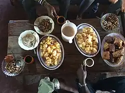 Image 11Mahamri/mandazi (Swahili doughnuts) served with miagna (cassava), cooked chickpeas and lentils, and chai (from Culture of Kenya)