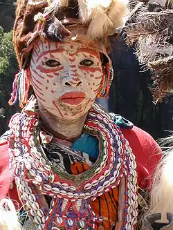 A Kĩkũyũ woman in traditional dress. Ceremonial face painting.