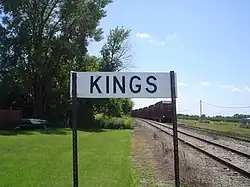 Sign along the railroad tracks for Kings