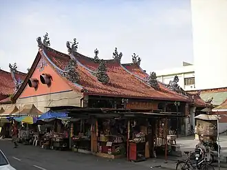 Roadside stalls selling prayer paraphernalia beside the Goddess of Mercy Temple.