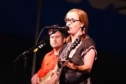 Veirs onstage playing guitar