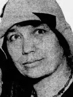 Leta Myers Smart, a woman with olive skin and dark hair and eyes, wearing a cloche-style hat