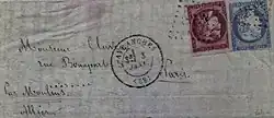 Color photograph of a letter with two stamps, one red, the other blue.