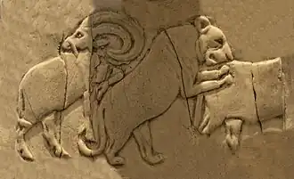 Lioness attacking a wild bull (Back, 4th register), another Mesopotamian motif.[35]
