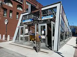 An angled glass entrance to a subway station