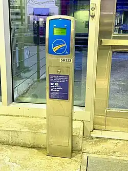 Card validator in front of the doors at platform 1 of Longueuil–Saint-Hubert station.
