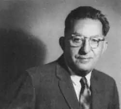 Portrait of Louis Abramson. He is wearing a business suit and eyeglasses.