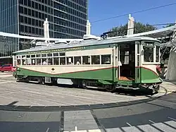 McKinney Avenue Transit Authority car 754, "Betty", a green and white streetcar, idle at the Uptown Trolley Station in Dallas, Texas.