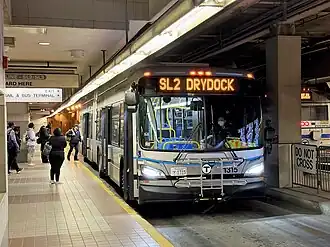 A silver-colored bus at an underground bus stations