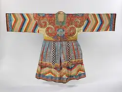 A colorful silk robe with long striped sleeves and a pleated skirt section, hanging with sleeves straight out on either side