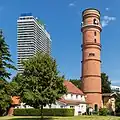 The old Travemünde lighthouse in front of the Maritim Hotel high-rise, on which the light is now mounted
