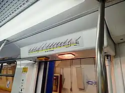 Line map of the MRT-3 (2017 version) above the doors with two mounted lights.