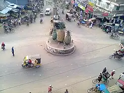 Madhupur Bus Stand, Tri-junction of three important roads of Bangladesh, The three roads goes to Tangail, Mymensingh and Jamalpur respectively. The pineapples signify the pineapple-growing area around Madhupur.