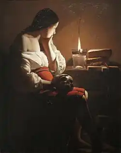 An oil painting of a pensive woman watching a candle, holding a skull