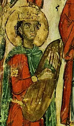 13th century, Russia. Man playing a gusli or rotte from the Simonovskaya Psalter. Playing holes would get smaller as the instrument became a lap-played psaltery.[50]