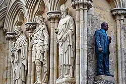Man with coffee by Sean Henry in a spare niche at the west end of the cathedral