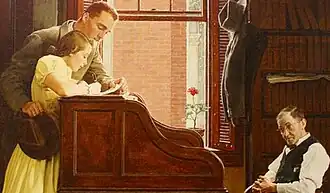 A man and woman standing in front of a large desk signing their marriage license