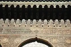 Details of the wood-carving along the top of the walls in the courtyard
