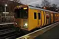 A Merseyrail Class 508 waits at the station.