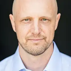 Headshot of Michael Hartl wearing a blue collared shirt