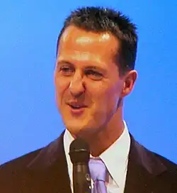 A man in his late thirties speaking into a microphone