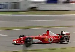Michael Schumacher driving a Ferrari without Marlboro branding in the United Kingdom