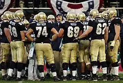 Midshipmen in huddle during 3rd quarter timeout