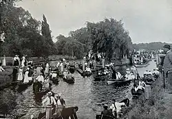 A postcard photograph of people boating on the River Thames near Molesey Lock c1897