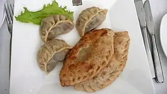 Two kinds of dumplings: buuz (top left) and khuushuur (lower right)