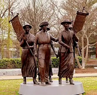 sculpture of five suffragists