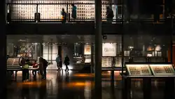 Interior view of the Musée Français de la Carte à Jouer in Issy-les-Moulineaux, France. The museum, dedicated to the history and art of playing cards, showcases a collection of historical decks, printing tools, and related artifacts. The exhibit space features informative displays, rare card sets, and interactive elements that explore the cultural significance of playing cards through the centuries.