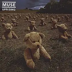 The single cover for "Uprising" depicts lines of teddy bears on a large field. The band name and song title are in the top left corner.