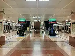 The lower platform level, with escalators leading up to the other levels of the station