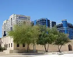 Part of the National Museum of Qatar with the skyline of Old Salata in the background