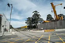 A level crossing with a bridge being built next to it