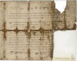 One-page, tan and brown, folded and tattered document from the Continental Congress that has mostly printed words but also handwritten text indicating that Adamson Tannehill has been approved as third lieutenant in Captain Otho Holland Williams company of riflemen.