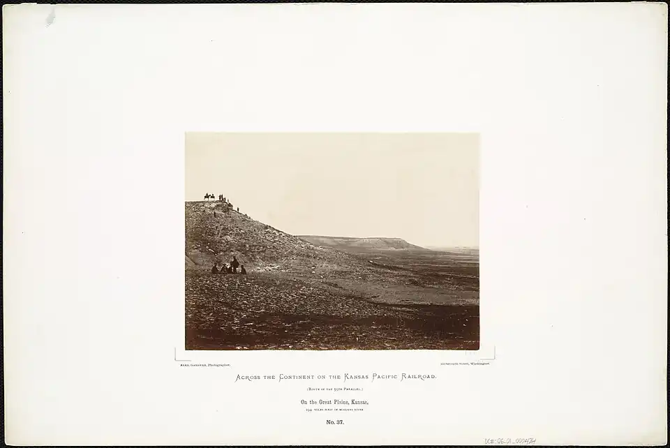 1867, bluffs west of Hays, behind the seated soldiers is pre-settlement digging in the Blue Hill Shale, possibly for selenite.