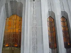 A series of tall windows at 1 Wall Street. Between each window are limestone piers.