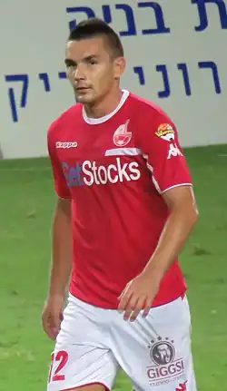 Ovidiu Hoban on the pitch, in a red jersey
