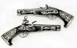Pair of Miquelet Pistols, in the Peninsular Spanish style, made in colonial Mexico, dated 1757, at the Metropolitan Museum of Art[17]