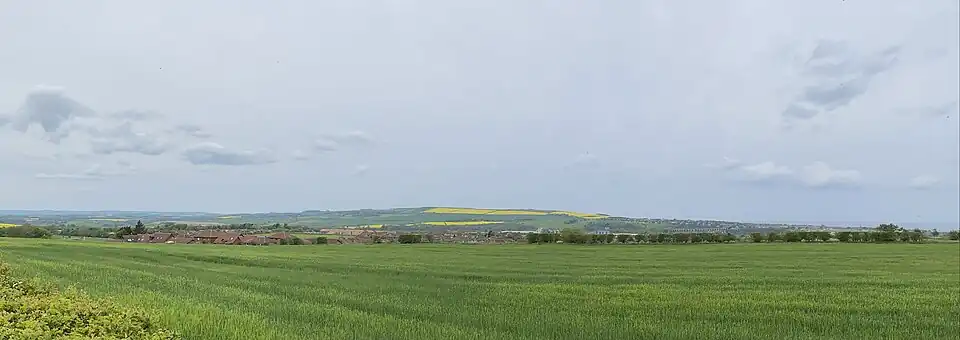 Panoramic view of Halidon Hill (centre) in 2023. The town of Berwick-upon-Tweed is to the east, on the North Sea coast.