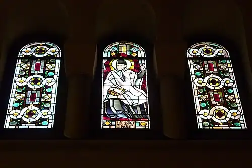 Saint Vincent de Paul window flanked by geometric windows