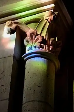 Decorated capitals of columns in the nave, coloured by light from stained glass