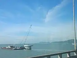 TNB monopoles under construction as of 2024 seen from Penang Bridge