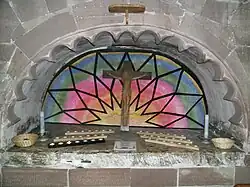 The early-16th-century tomb alcove of Richard Littleton and Alice Wynnesbury in the south nave aisle, now used for votive candles. Originally this part of the church was a Littleton family chapel.
