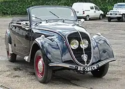 Peugeot 202 cabriolet. The protected position of the headlights behind the grill became a key identifier for the Peugeot brand during the 1930s.